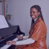 Lady playing piano and smiling